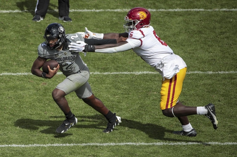 BOULDER, CO - SEPTEMBER 30: Colorado Buffaloes quarterback Shedeur Sanders (2) gets away fromn USC Trojans defensive lineman Anthony Lucas (6) during a college football game between the USC Trojans and the Colorado Buffaloes on September 30, 2023, at Folsom Field in Boulder, Colorado.(Photo by Jevone Moore/Icon Sportswire) (Icon Sportswire via AP Images)